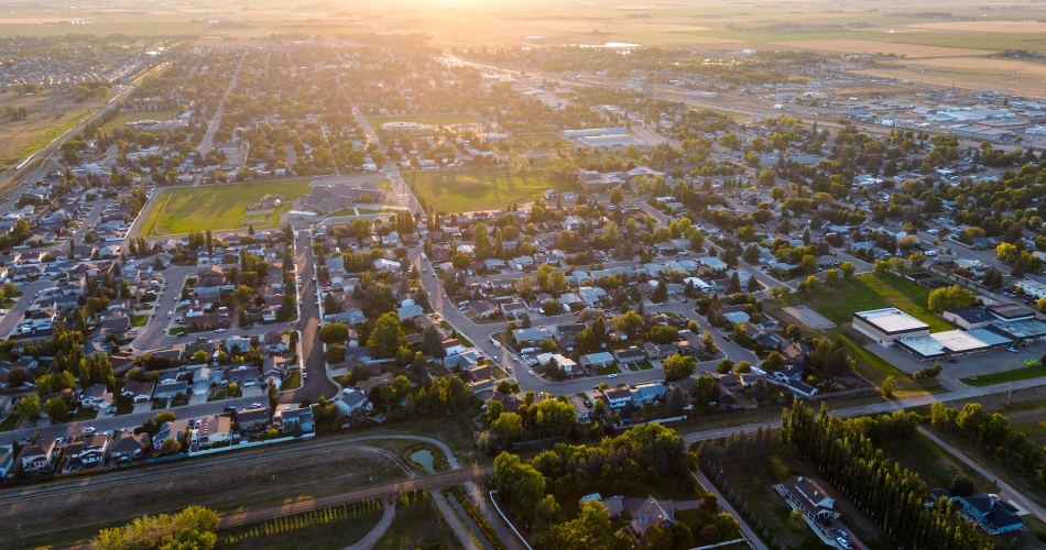 Coaldale, Alberta from the air at sunset, its streets running out to the surrounding farmland